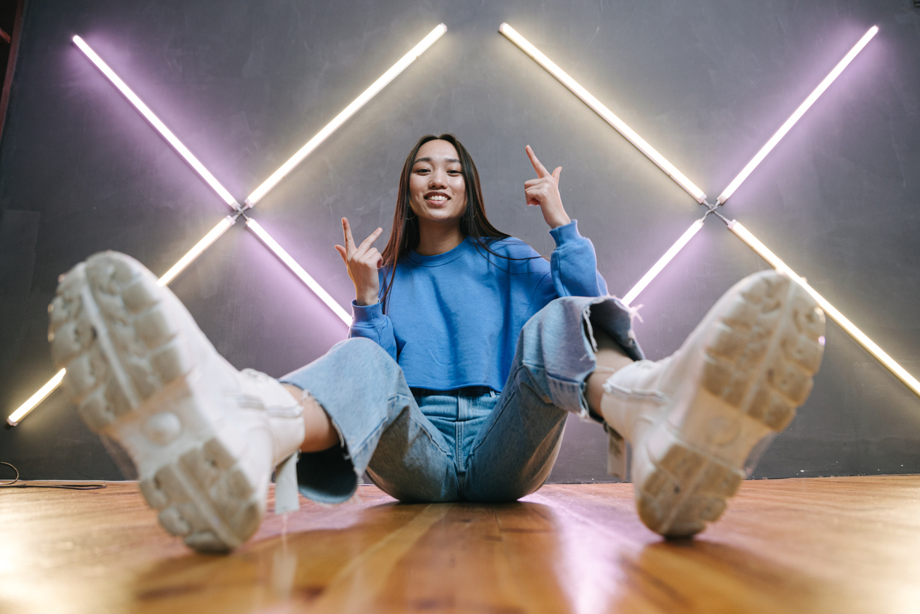 A Woman in Blue Sweater Sitting on the Floor